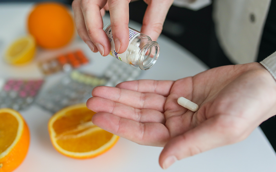Supplements Men Should Think Twice About, image of a man with his hand out with a supplement on it.