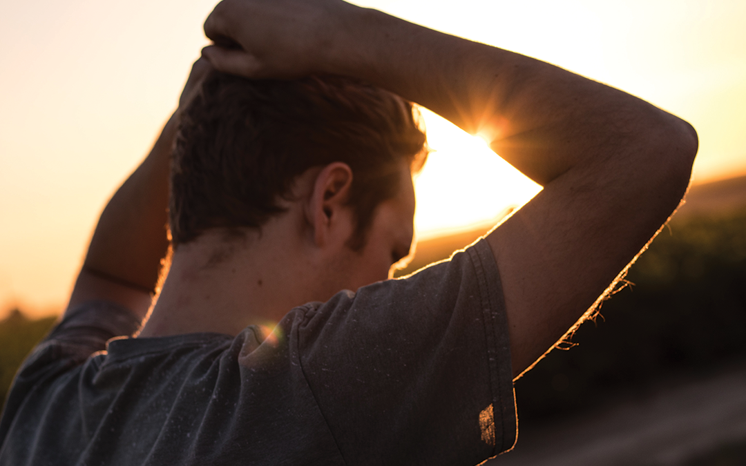 Sense-of-Purpose, image of a man with his arms behind his head during a sunset.
