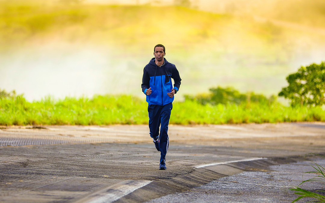 Boost Testosterone, Man running with blue jacket on, sunset