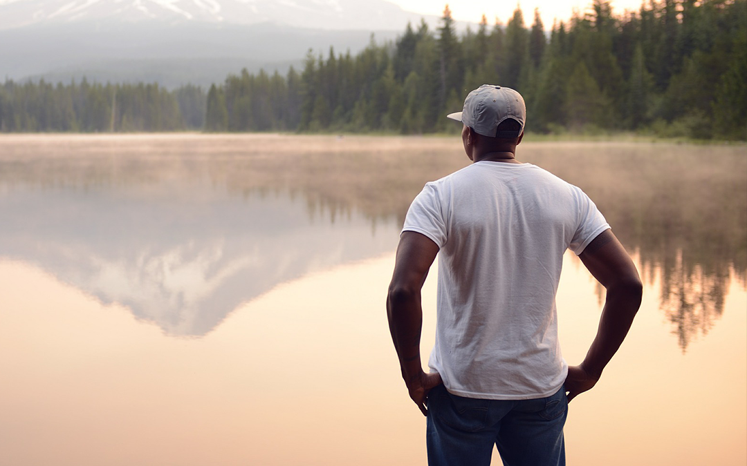 meditation misconceptions, man standing in front of a lake looking at his surroundings