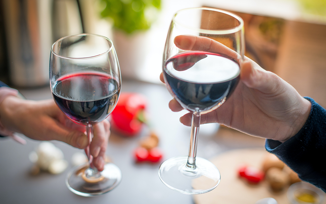 wine glasses, Healthiest Alcohol, image of two hands cheering with red wine