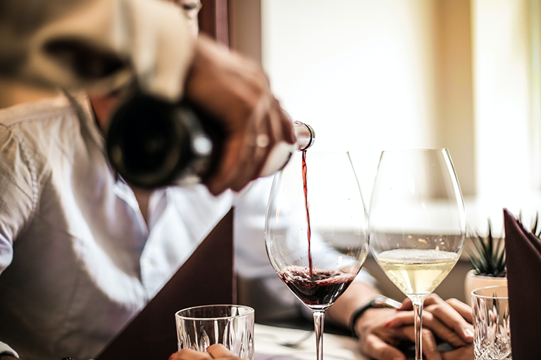red wine, Are You Drinking the Best Red Wine for Heart Health, image of a man at a table being served red wine