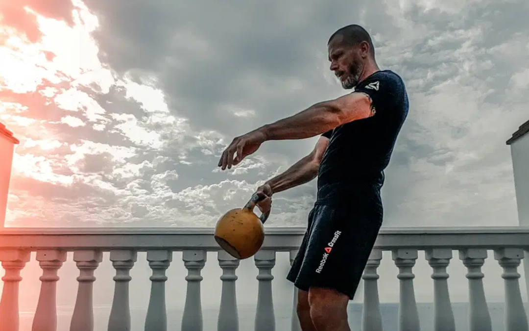 What Is A Definite Sign Of Overtraining, image of a man using a dumbbell