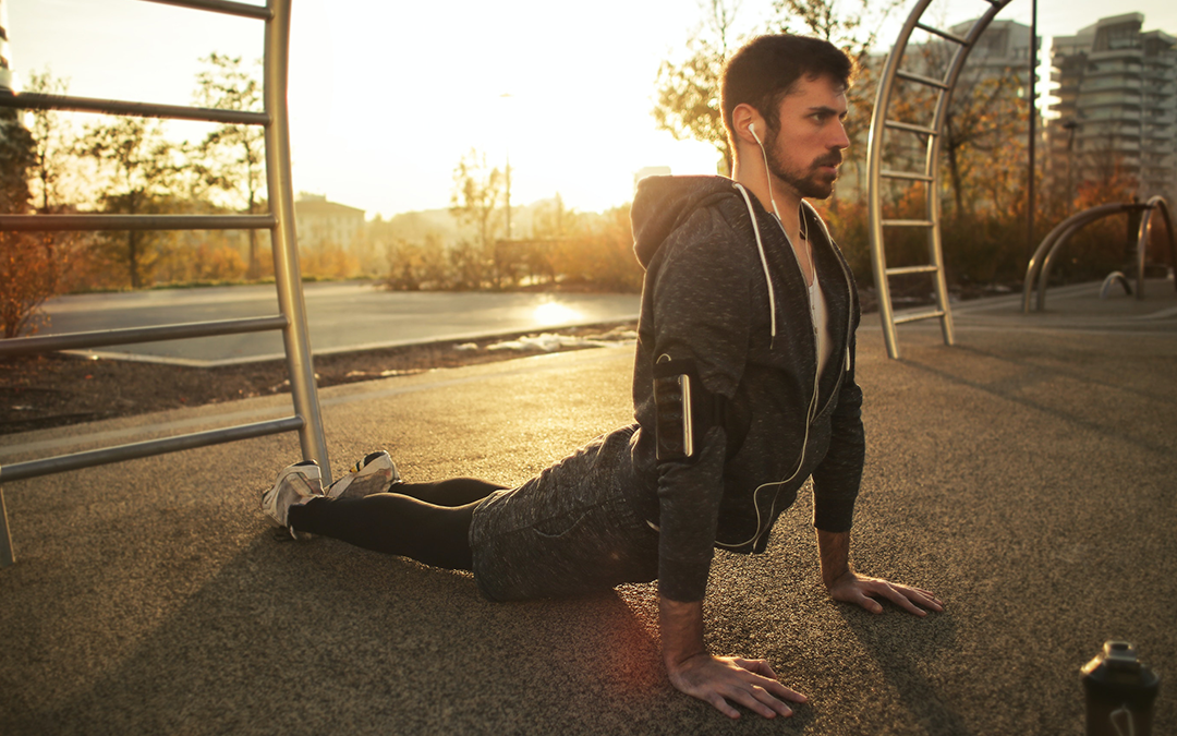 Rev Up Your Fitness Goals for Lasting Wellness with These Simple Tricks, image of a man doing yoga on the ground outside