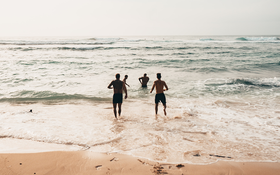 social connection, Can Social Connection Keep You Healthy? How Connectedness Impacts Your Health, image of friends having fun at the beach running into the ocean.