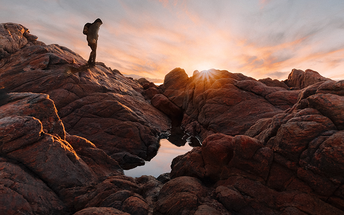Nature Immersion, Nature Immersion: Understanding The Benefits Of Connecting With Nature, image of a man hiking with a sunset in the background