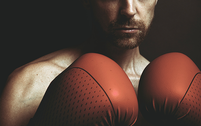Stoicism: Understanding The Disciplines of The Man Code, image of a man with boxing gloves on.